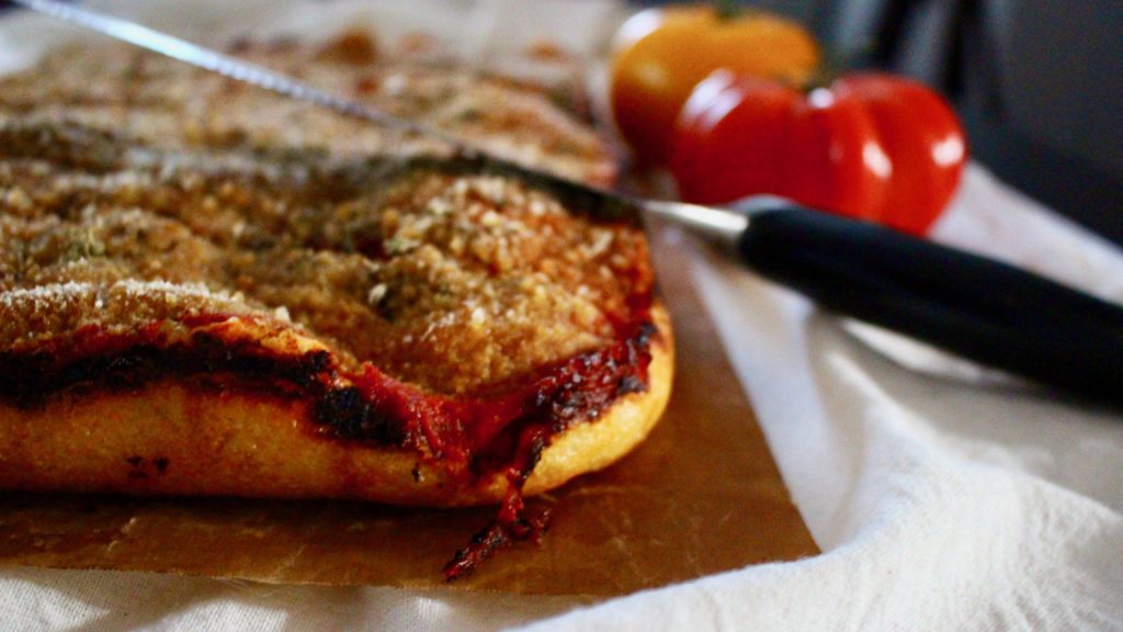 A spongy pizza crust topped with anchovies, Pecorino Romano, tomato sauce, onions and breadcrumbs.