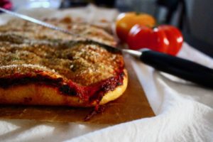 A spongy pizza crust topped with anchovies, Pecorino Romano, tomato sauce, onions and breadcrumbs.