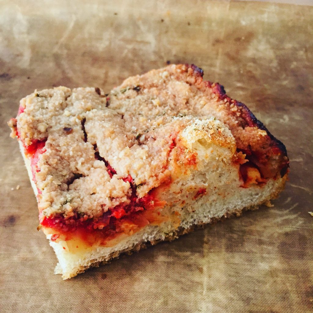 A spongy pizza crust topped with anchovies, Pecorino Romano, tomato sauce, onions and breadcrumbs. 