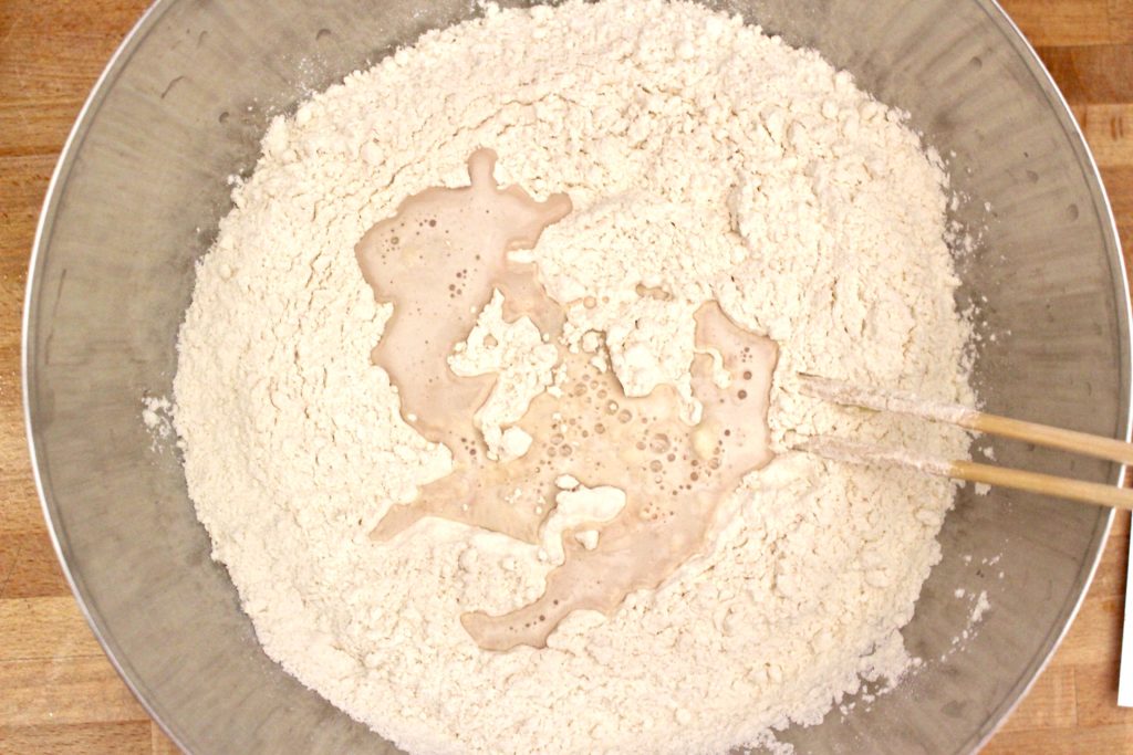 Mixing flour with yeast for pizza dough