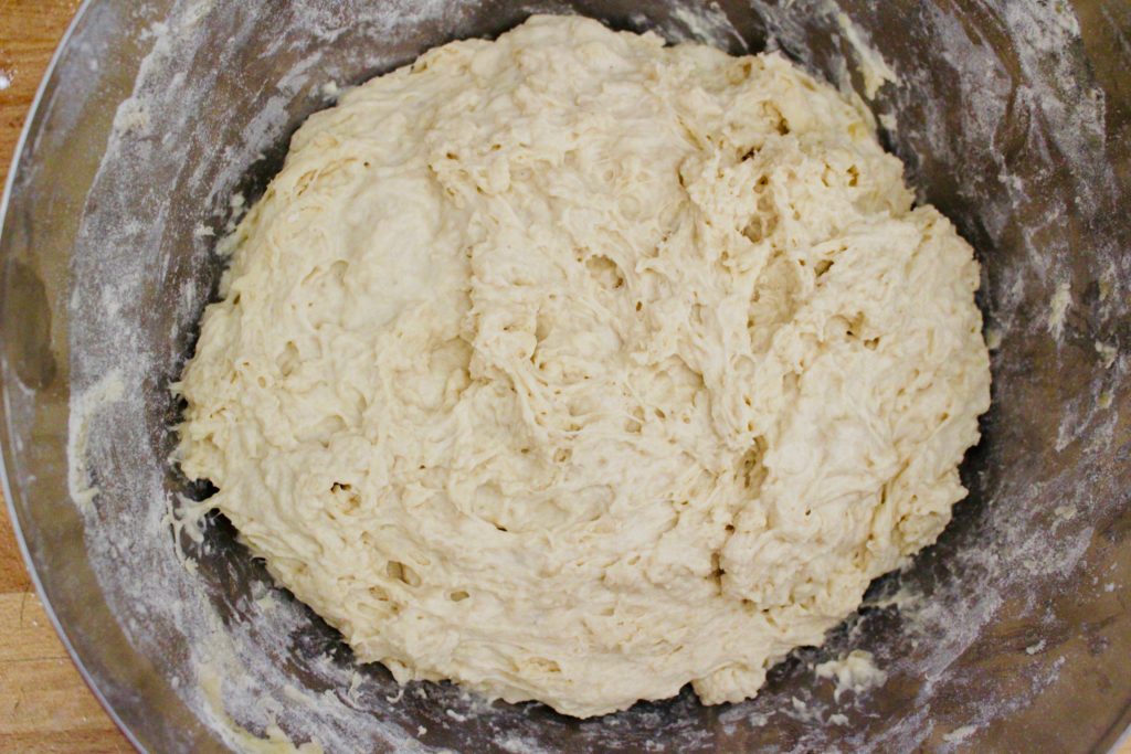After mixing flour with yeast and water for pizza dough