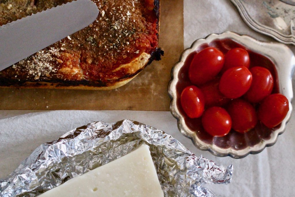 A spongy Sicilian pizza crust topped with anchovies, Pecorino Romano, tomato sauce, onions and breadcrumbs. 