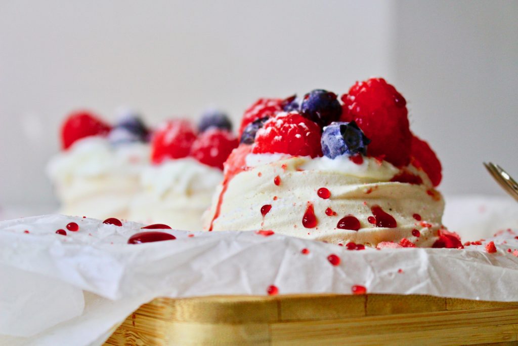 Mini Pavlova: meringue with whipped cream and berries. Dusted with powder sugar. Berry Nice!