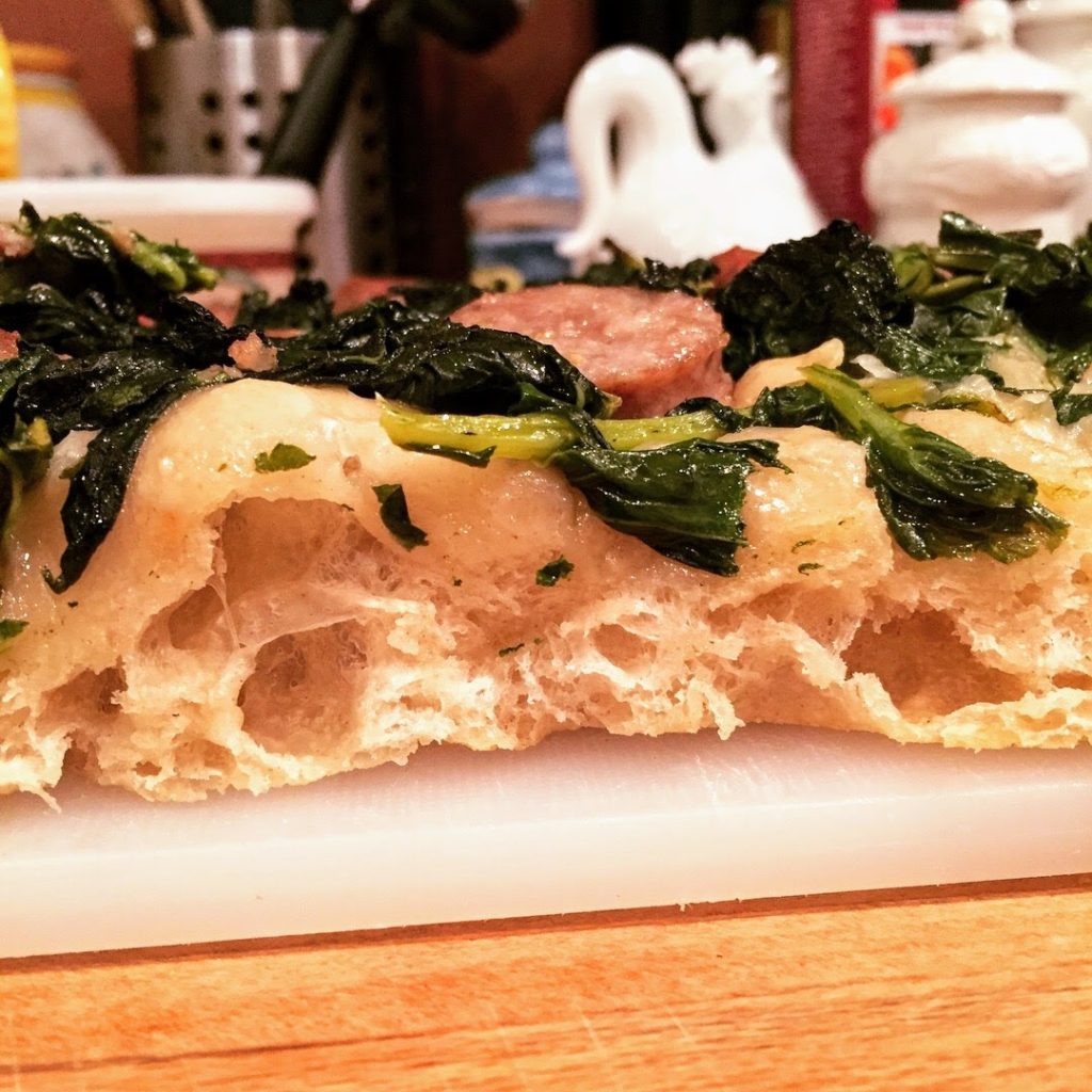 Pizza Bianca topped with sauteed broccoli rabe and sausage