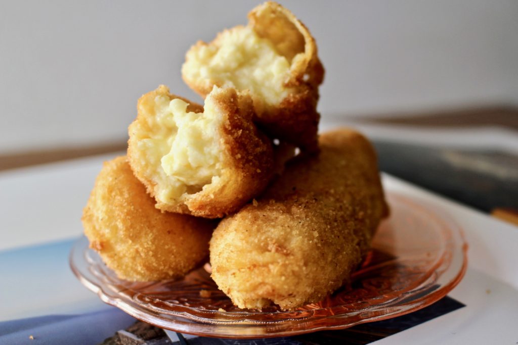 thre pieces of milk croquette on a pink glass dish