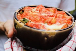 Delicious and tender gnocchi served sorrentina style: baked in a deep dish with homemade tomato sauce and flavored with lots of mozzarella and basil.