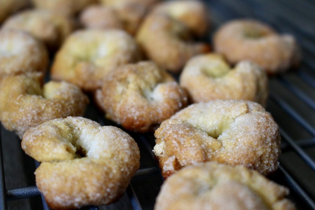 ciambelline al Vino on a tray. Crunchy ring shaped cookies made with wine and covered in sugar