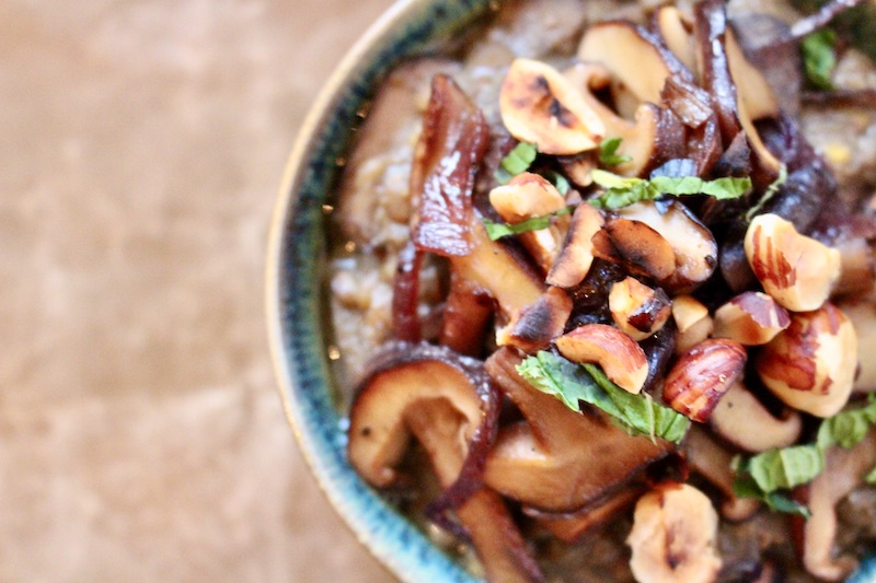 Lentil Miso soup with Shiitake mushrooms and hazelnuts serven in a green bowl