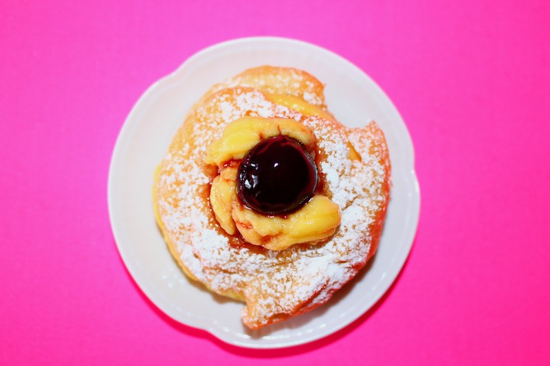 Zeppole di San Giuseppe filled with pastry cream and topped with an amarena cherry