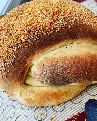 a small loaf of Sicilian bread made with semolina flour and topped with sesame seeds. 