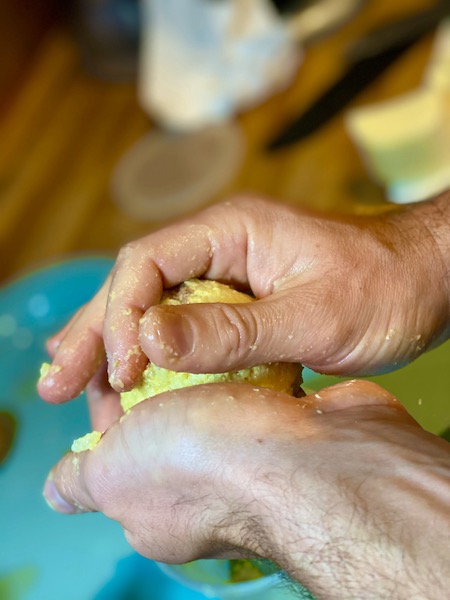 male hands shaping arancini
